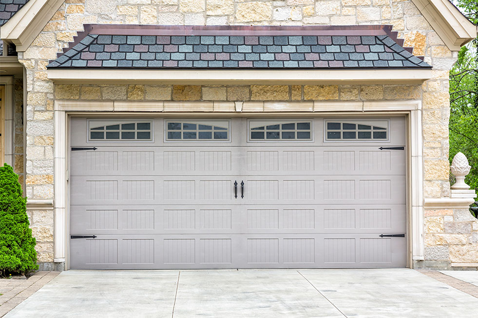 Gray attached garage door with four rectangular glass windows