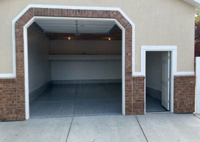 A tall entryway Garage with a walk in door
