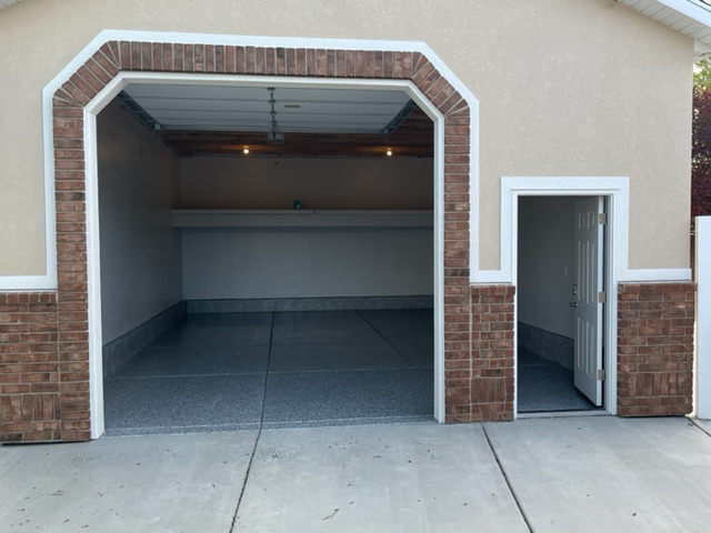 A tall entryway Garage with a walk in door 