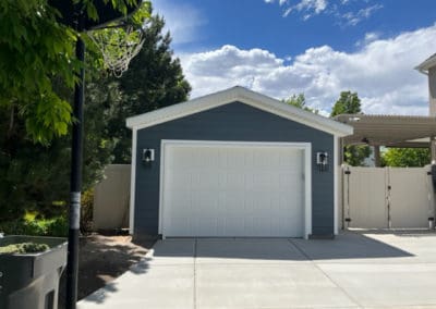 Front view of a blue detached garage