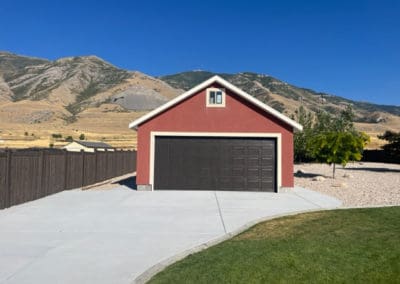 Front view of a brown garage door on a red-orange detached garage