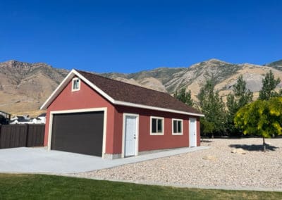 Side view of a brown garage door on a red-orange detached garage