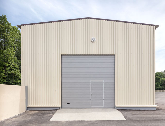 Industrial storehouse with closed gray metal gate